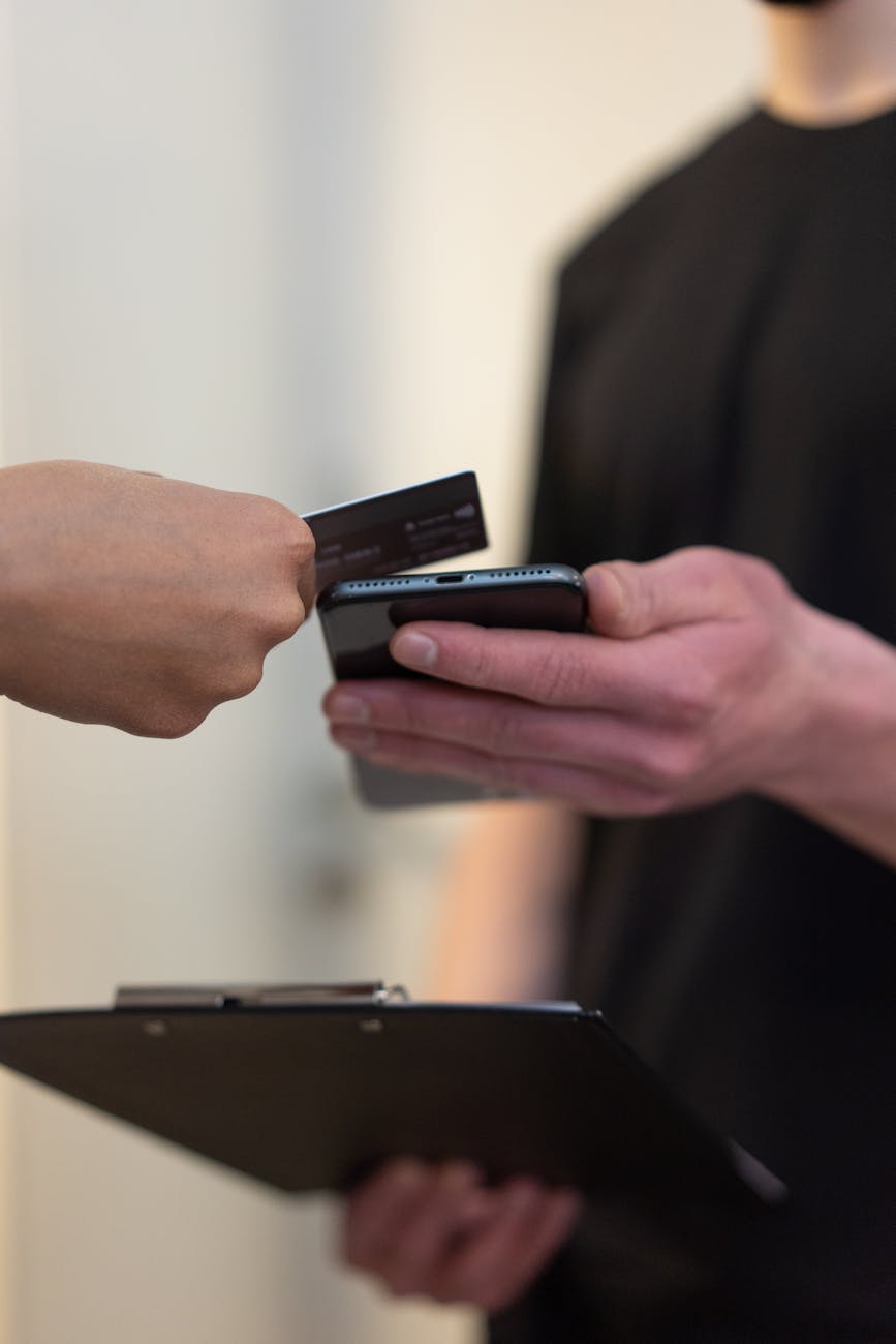 a person sharing his contact by tapping his digital business card on another's mobile